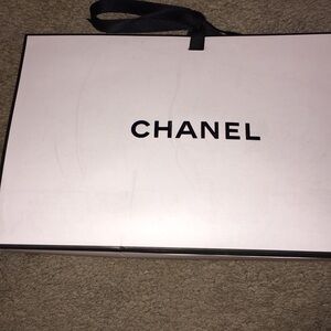 Authentic Chanel gift bag with black ribbon tie. Measures  9x6x3